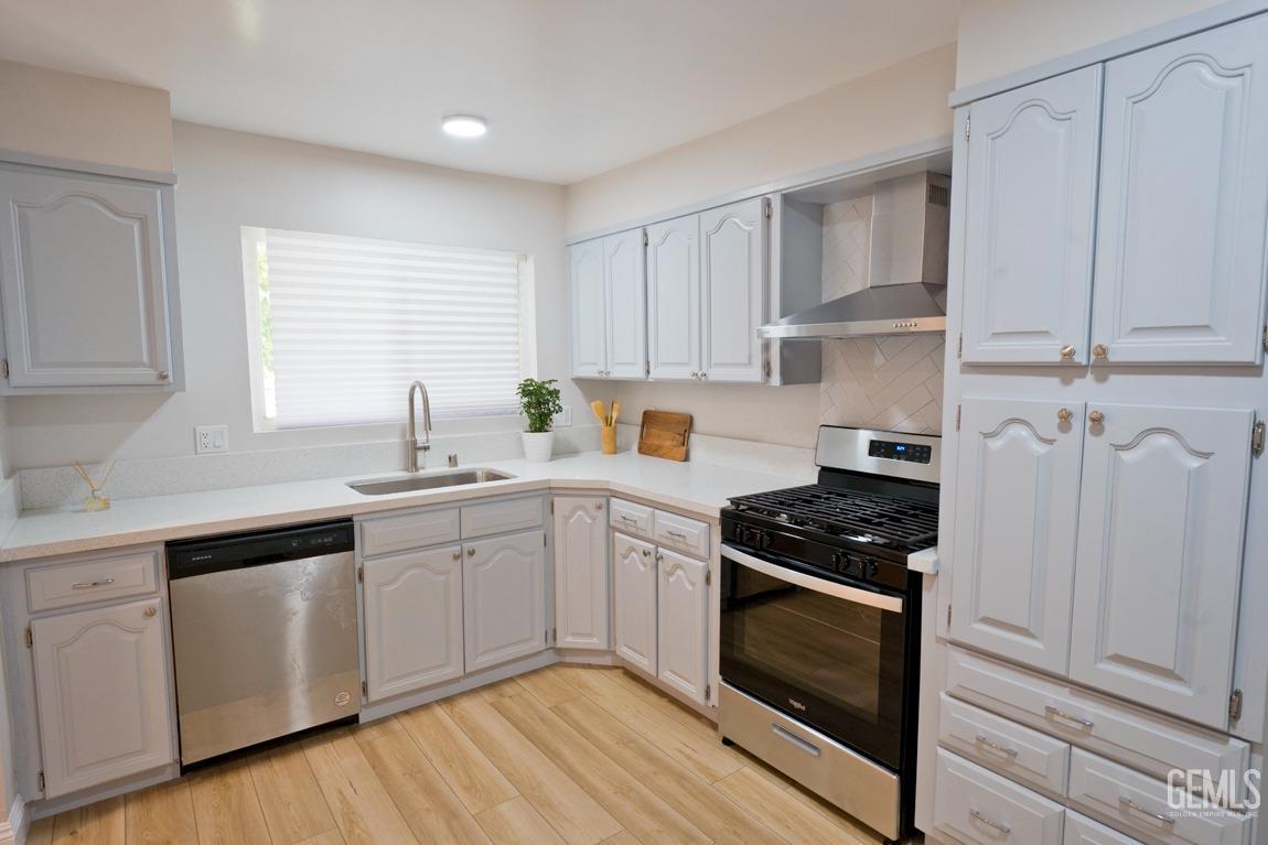 Undisclosed Address Bakersfield, CA 93304 - Photo 5 of 20 a kitchen with white cabinets and appliances