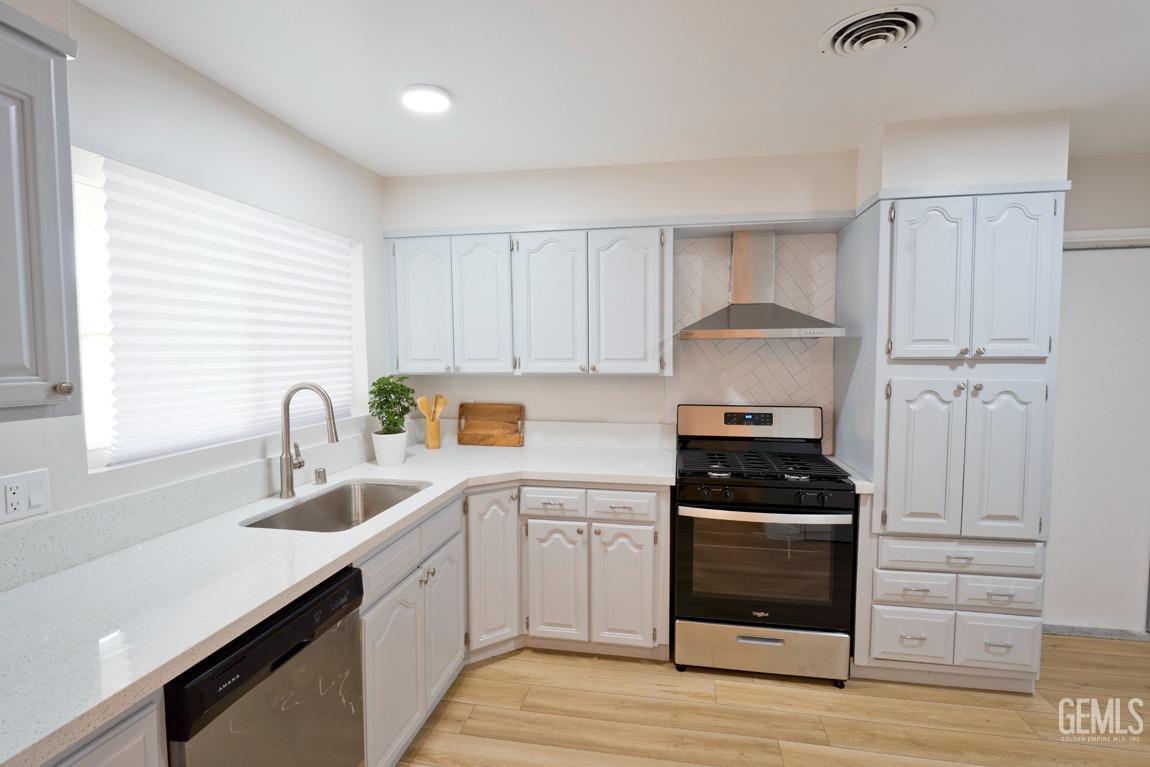 Undisclosed Address Bakersfield, CA 93304 - Photo 6 of 20 a kitchen with granite countertop white cabinets and appliances