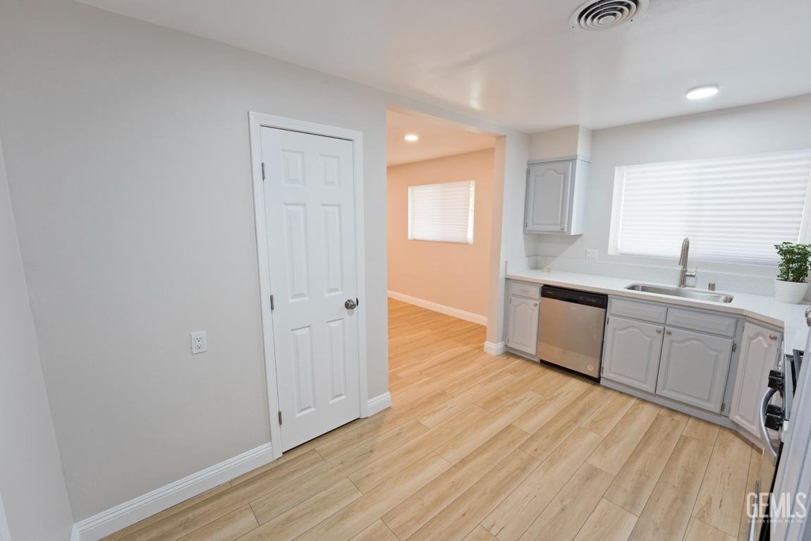 Undisclosed Address Bakersfield, CA 93304 - Photo 7 of 20 a view of a kitchen with wooden floor