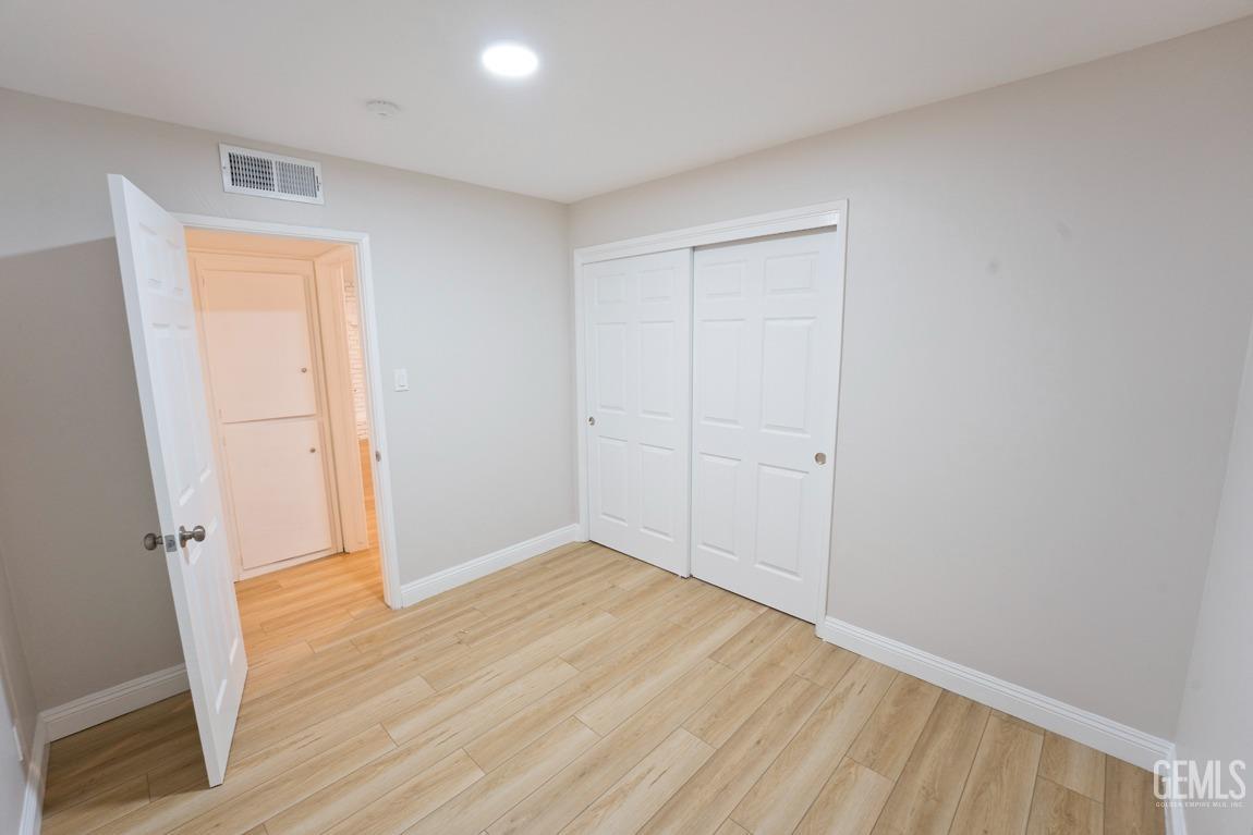 Undisclosed Address Bakersfield, CA 93304 - Photo 9 of 20 an empty room with wooden floor and closet