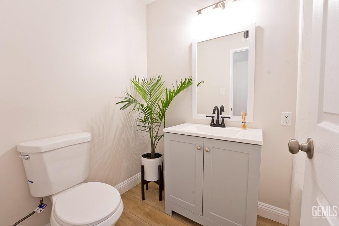 Undisclosed Address Bakersfield, CA 93304 - Photo 10 of 20 a bathroom with a toilet sink and mirror