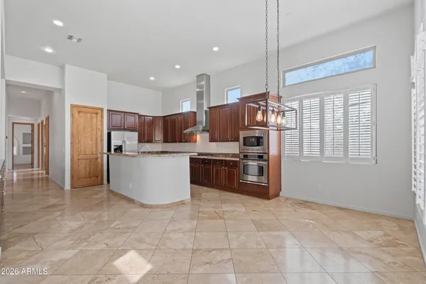 a kitchen with stainless steel appliances a refrigerator and a stove top oven