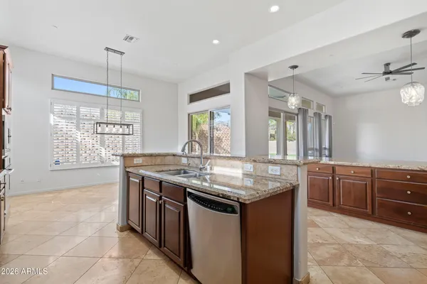 a kitchen with stainless steel appliances granite countertop a stove a sink dishwasher and a oven with granite countertops