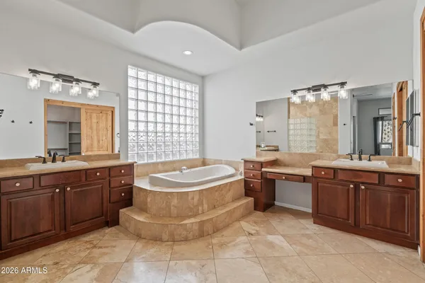 a spacious bathroom with a sink a large mirror and a bathtub
