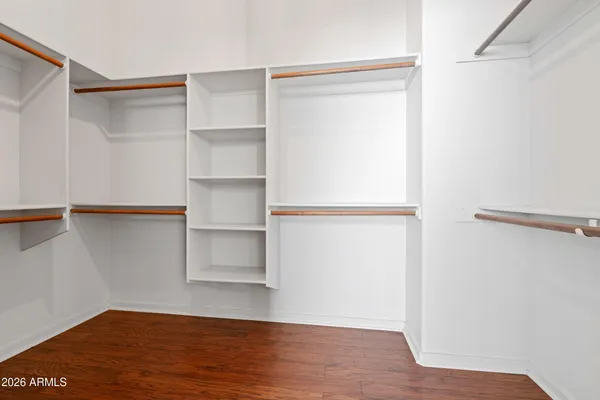 a view of an empty walk in closet with empty racks