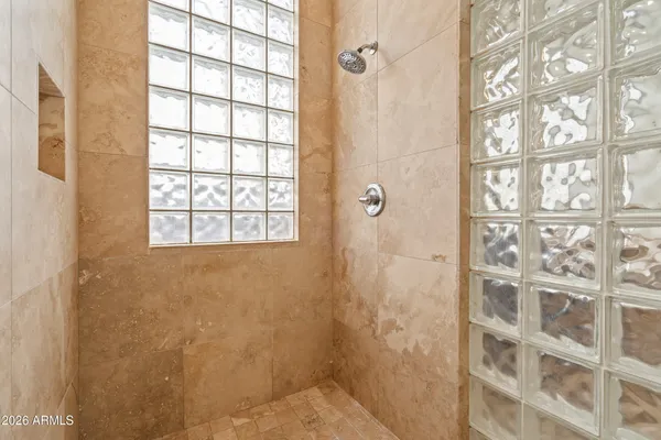 a bathroom with a window and a shower