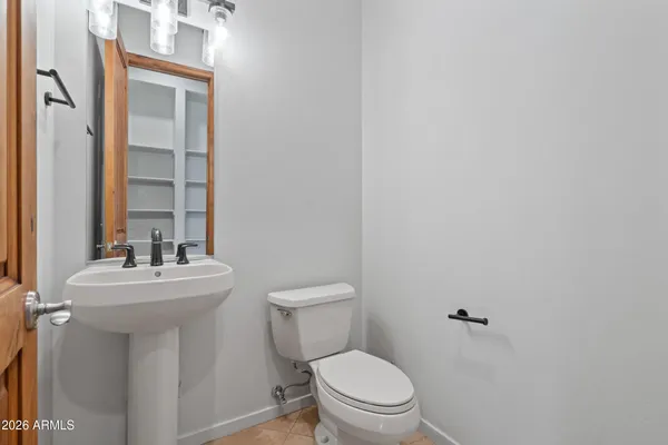 a bathroom with a sink mirror and toilet