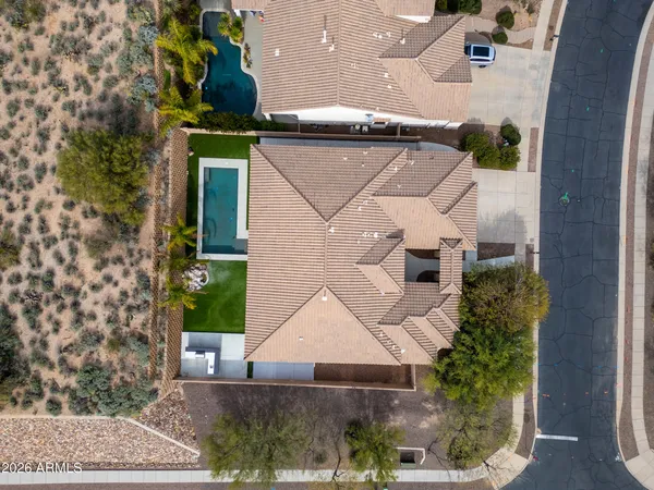 an aerial view of a house with a mountain