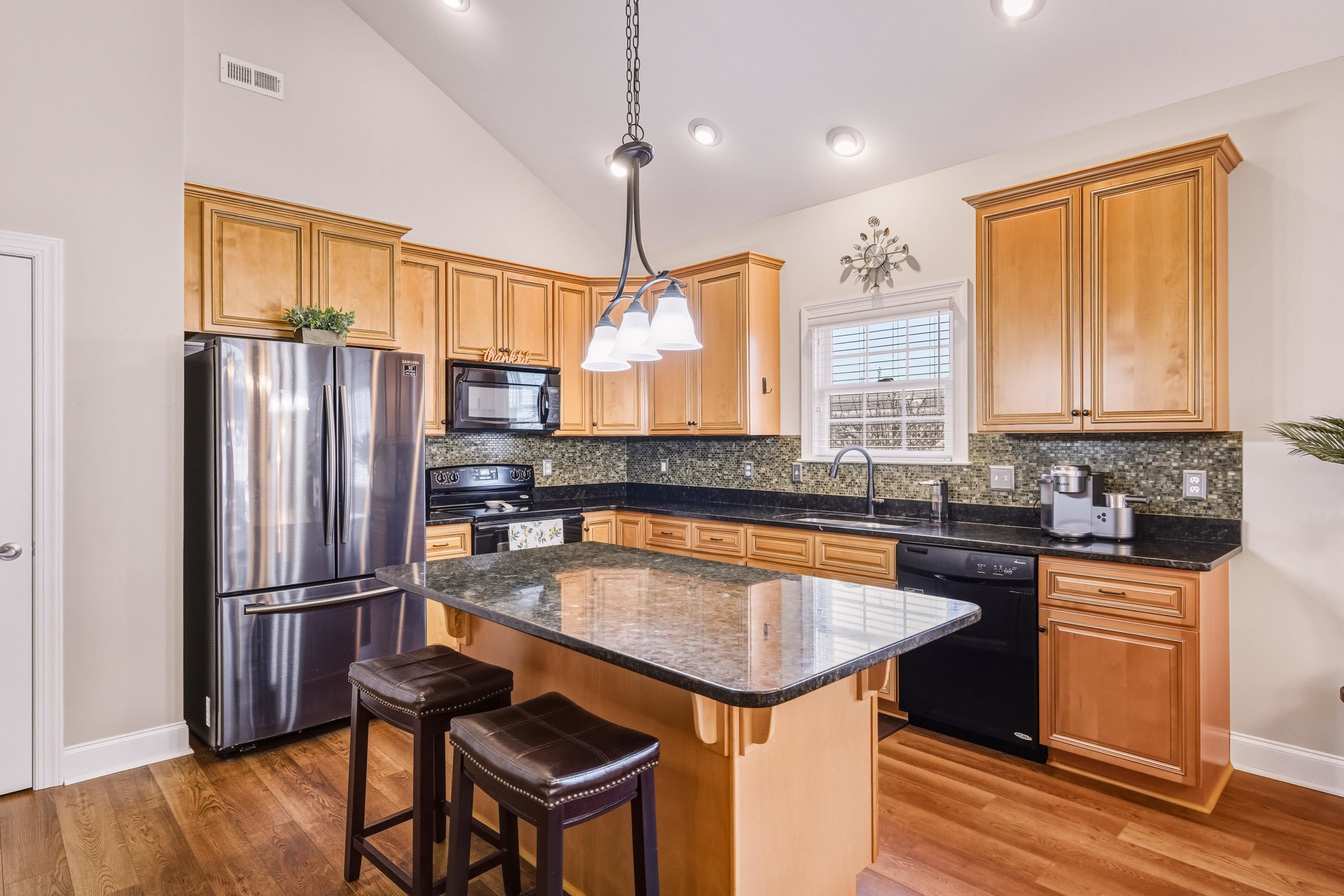 470 Callaway Circle Harrisonburg, VA 22801 - Photo 4 of 73 a kitchen with stainless steel appliances granite countertop a refrigerator a sink dishwasher a dining table and chairs with wooden floor