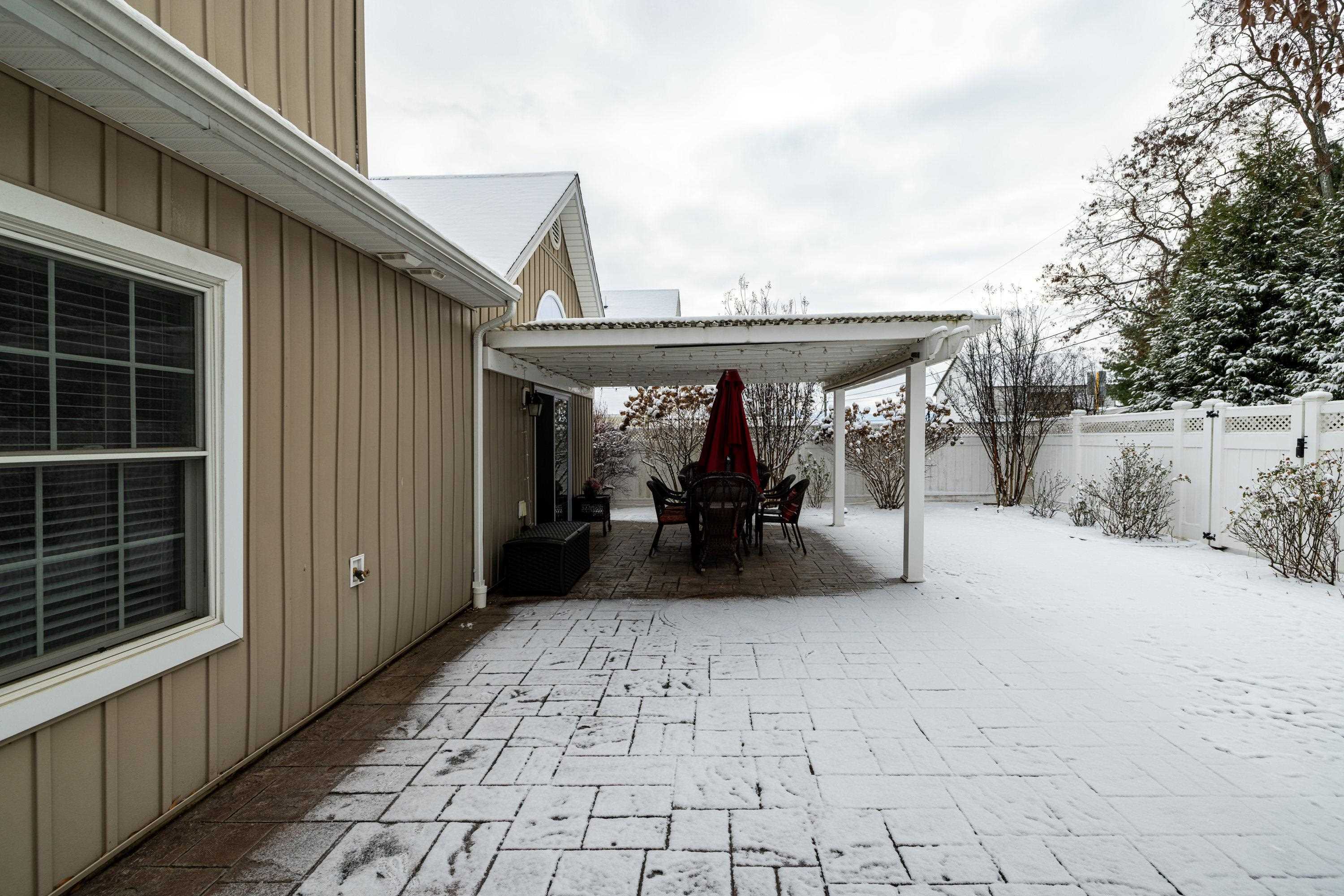 470 Callaway Circle Harrisonburg, VA 22801 - Photo 55 of 73 The backyard of the home features a large patio and covered patio area. The backyard offers mature landscaping, a mostly level lot, and is fully fenced with yinyl fencing.
