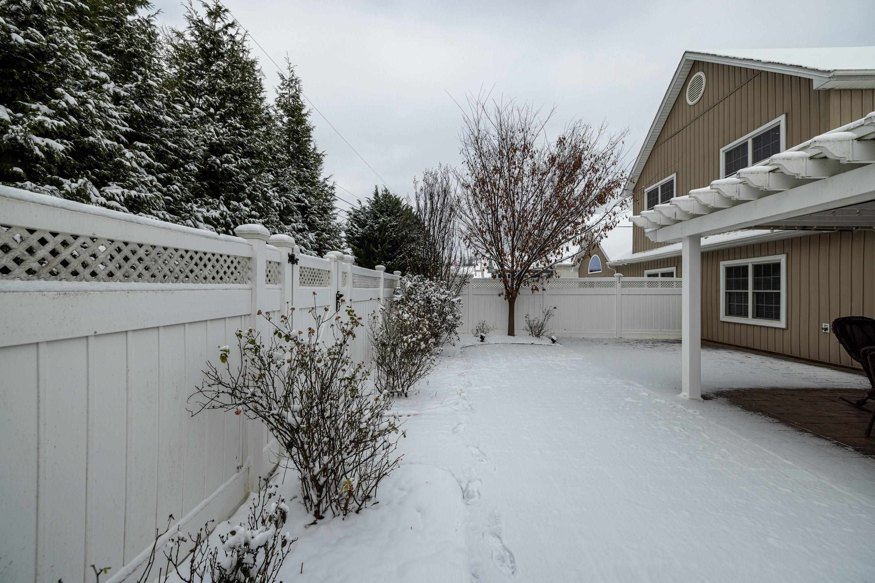 470 Callaway Circle Harrisonburg, VA 22801 - Photo 59 of 73 The backyard of the home features a large patio and covered patio area. The backyard offers mature landscaping, a mostly level lot, and is fully fenced with yinyl fencing.