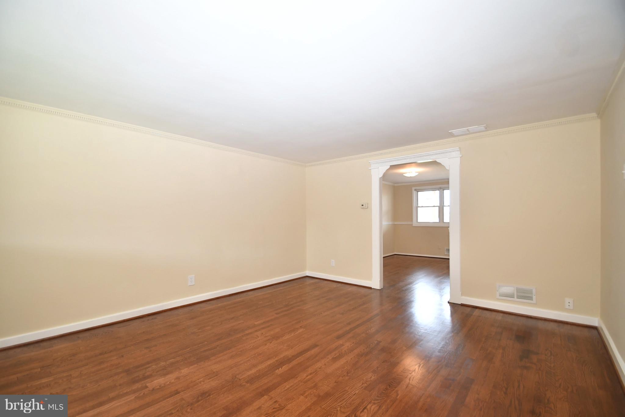 7826 Kentley Road Dundalk, MD 21222 - Photo 4 of 21 a view of an empty room and wooden floor