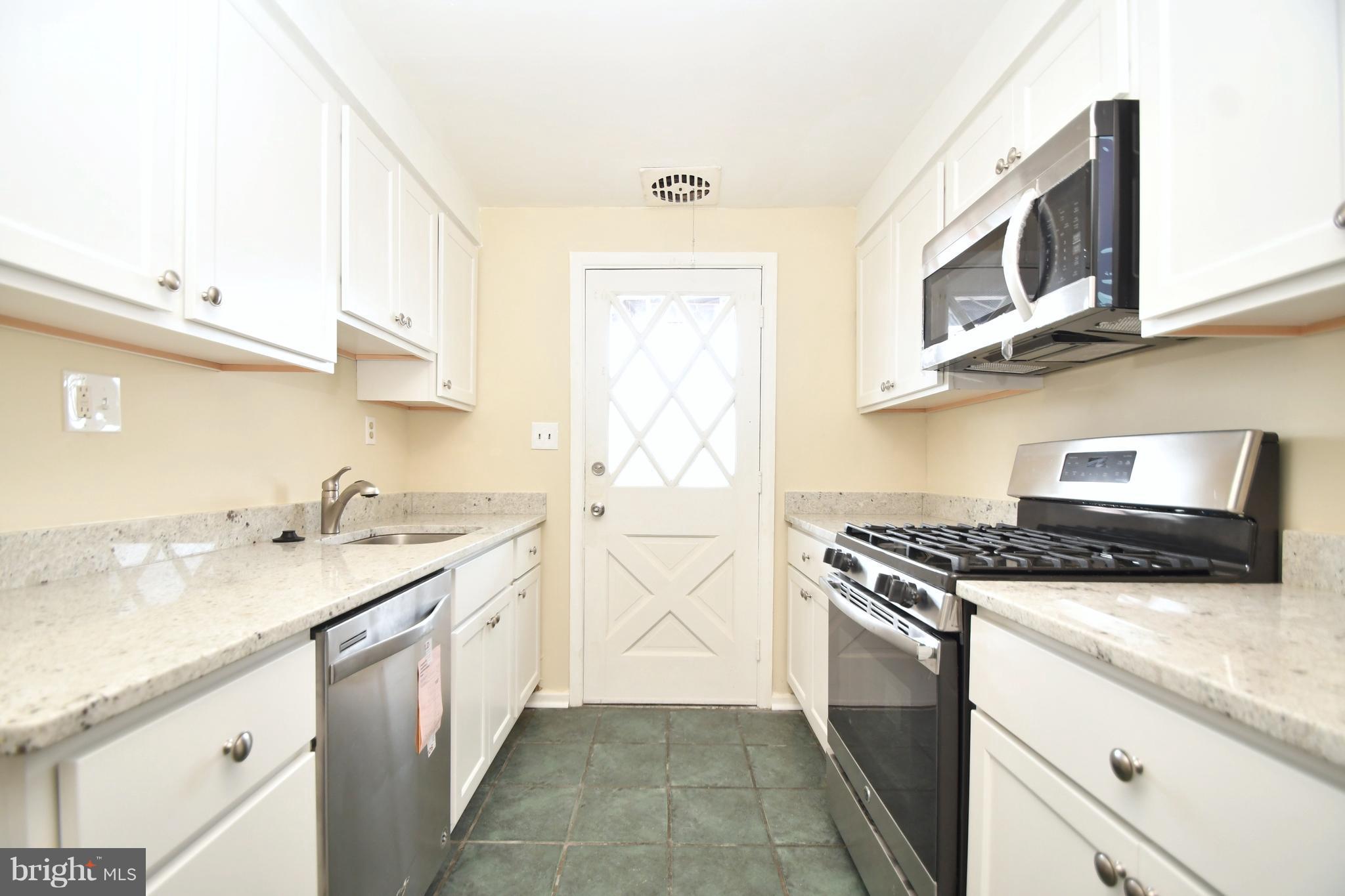7826 Kentley Road Dundalk, MD 21222 - Photo 5 of 21 a kitchen with stainless steel appliances granite countertop a sink and a stove