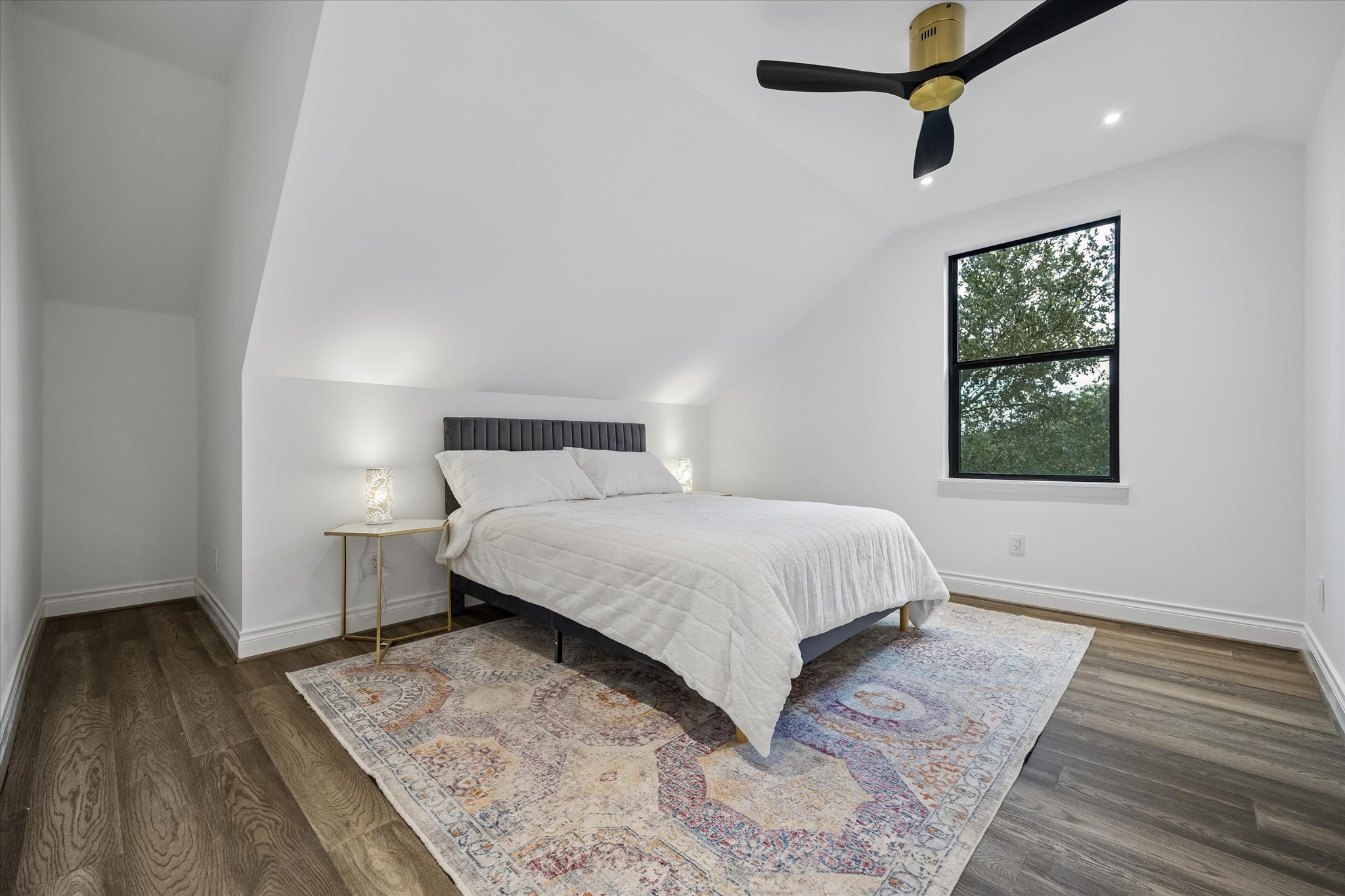 3719 Bee Creek Road Spicewood, TX 78669 - Photo 24 of 40 Sloping ceilings add unique character to this well-lit bedroom featuring modern fixtures.