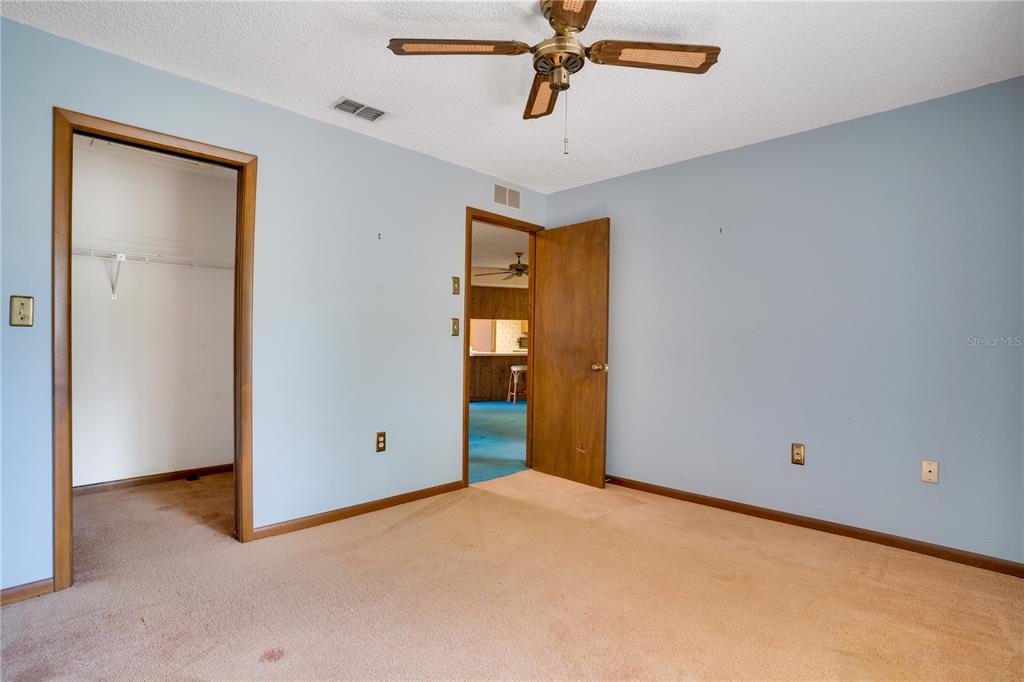 12161 100th Avenue Seminole, FL 33772 - Photo 20 of 34 a view of a room with a ceiling fan and closet
