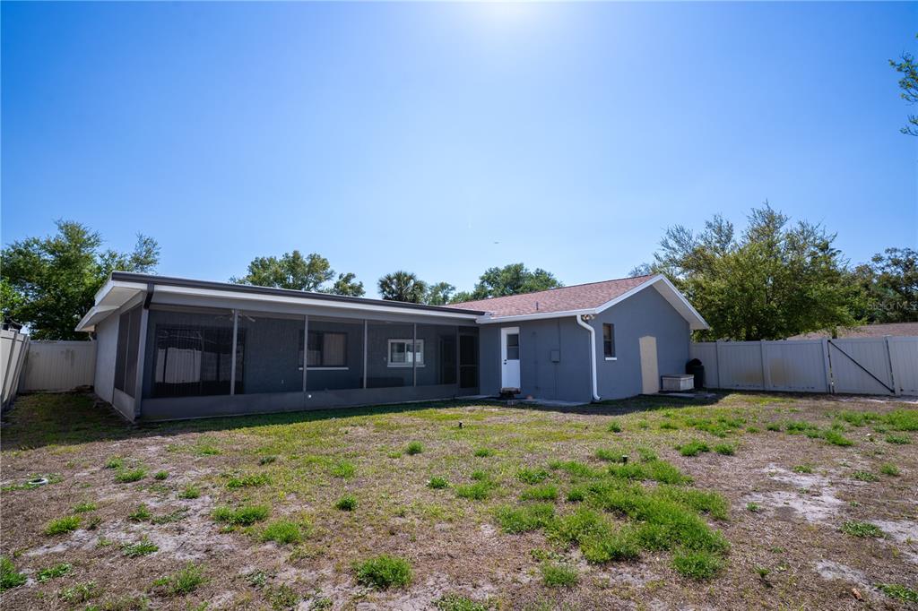 12161 100th Avenue Seminole, FL 33772 - Photo 7 of 34 a view of a house with a yard and potted plants