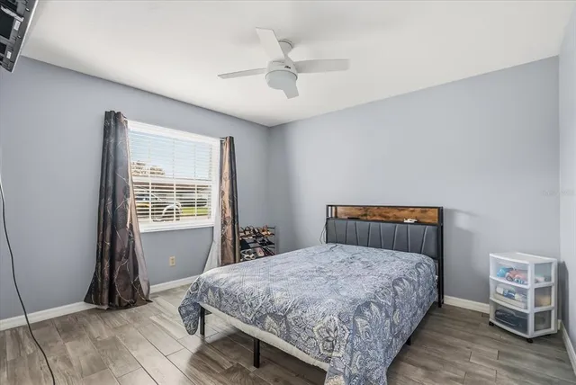 a bedroom with a bed and a window