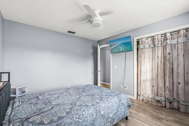 a bedroom with a bed and a window