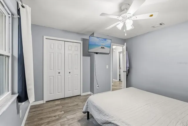 a bedroom with a bed and a chandelier