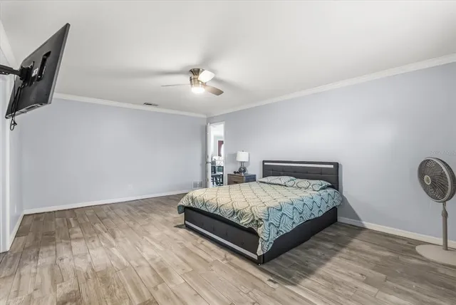 a bedroom with a bed and painting on the wall