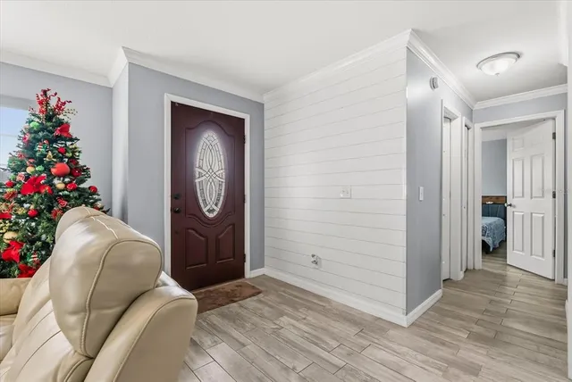 a hallway with beautiful frames and flower vase