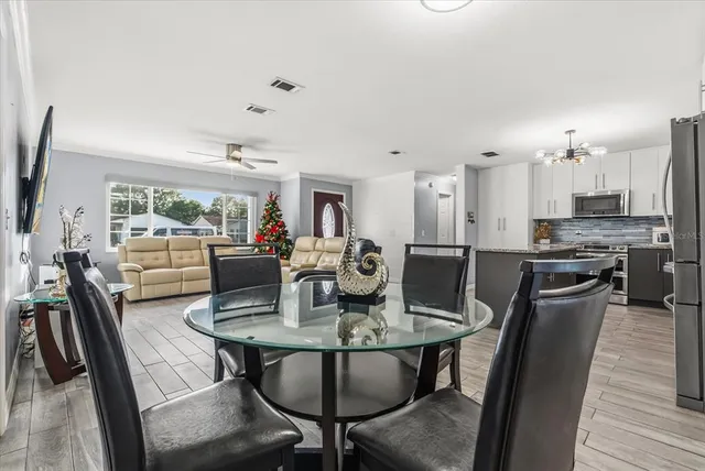 a view of a dining room with furniture and wooden floor