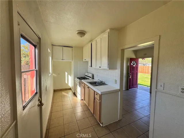 a kitchen with granite countertop a stove and a refrigerator