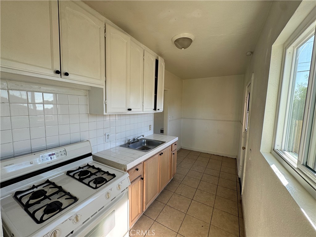 14880 Randall Avenue Fontana, CA 92335 - Photo 7 of 14 a kitchen with a stove and a sink