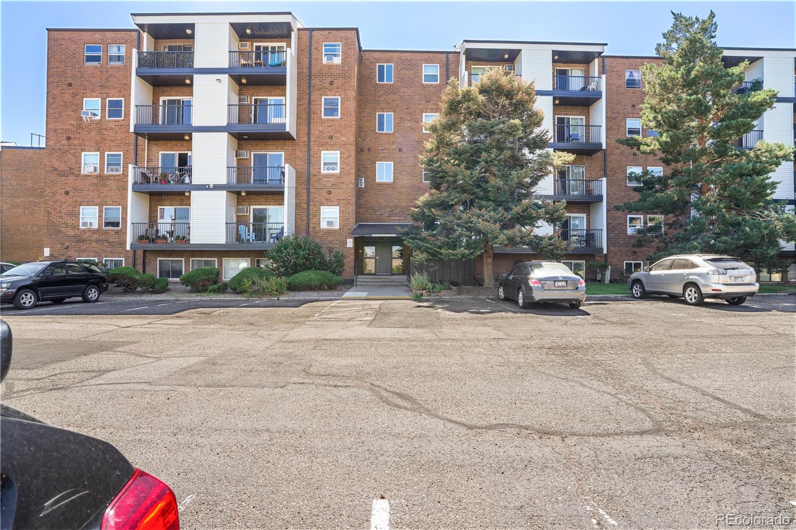 a car parked in front of a brick building