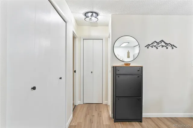 a view of a refrigerator in kitchen with wooden floor