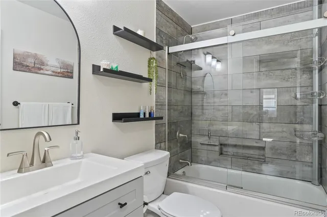 a bathroom with a sink mirror bathtub and toilet