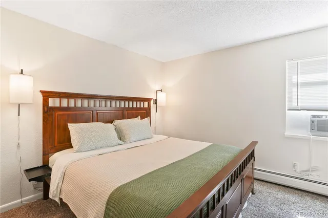 a bedroom with a bed and window