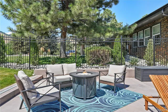 a view of a patio with couches chairs and a fire pit