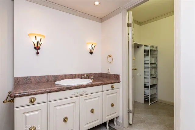 a bathroom with a granite countertop sink a mirror and a bathtub