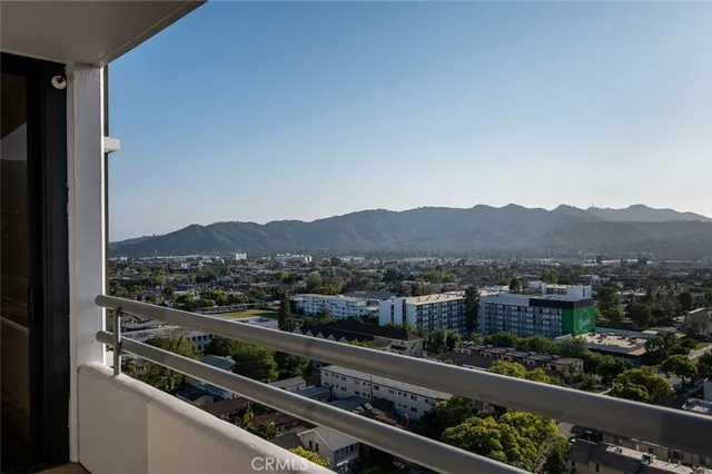 a view of a chairs and table on wooden deck with water view