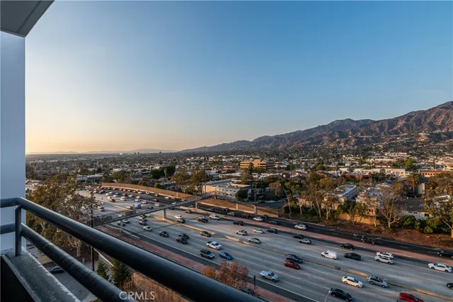 a view of a chairs and table on the roof deck