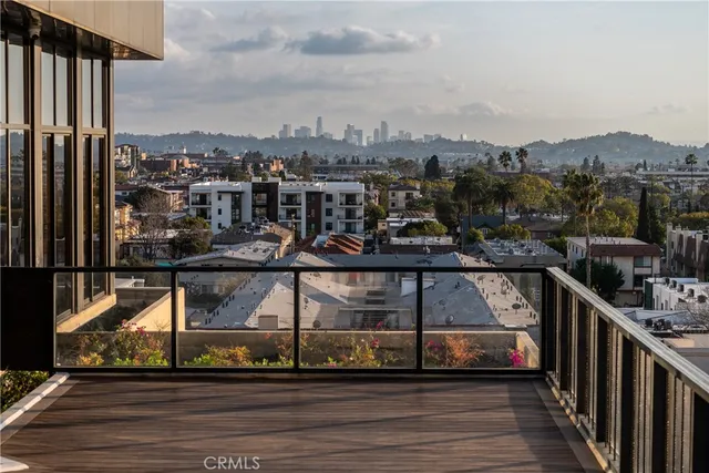 a kitchen with stainless steel appliances granite countertop a sink a stove and a wooden floors