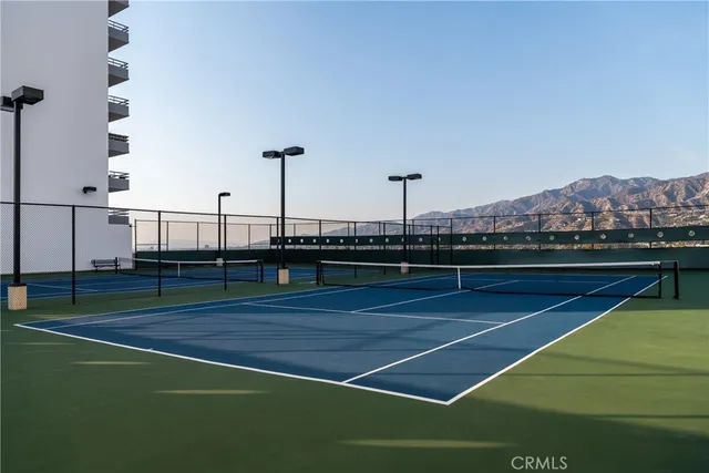 a kitchen with stainless steel appliances kitchen island granite countertop a stove and a white cabinets