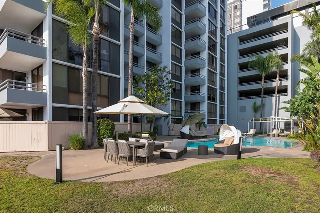a patio with a table and chairs under an umbrella