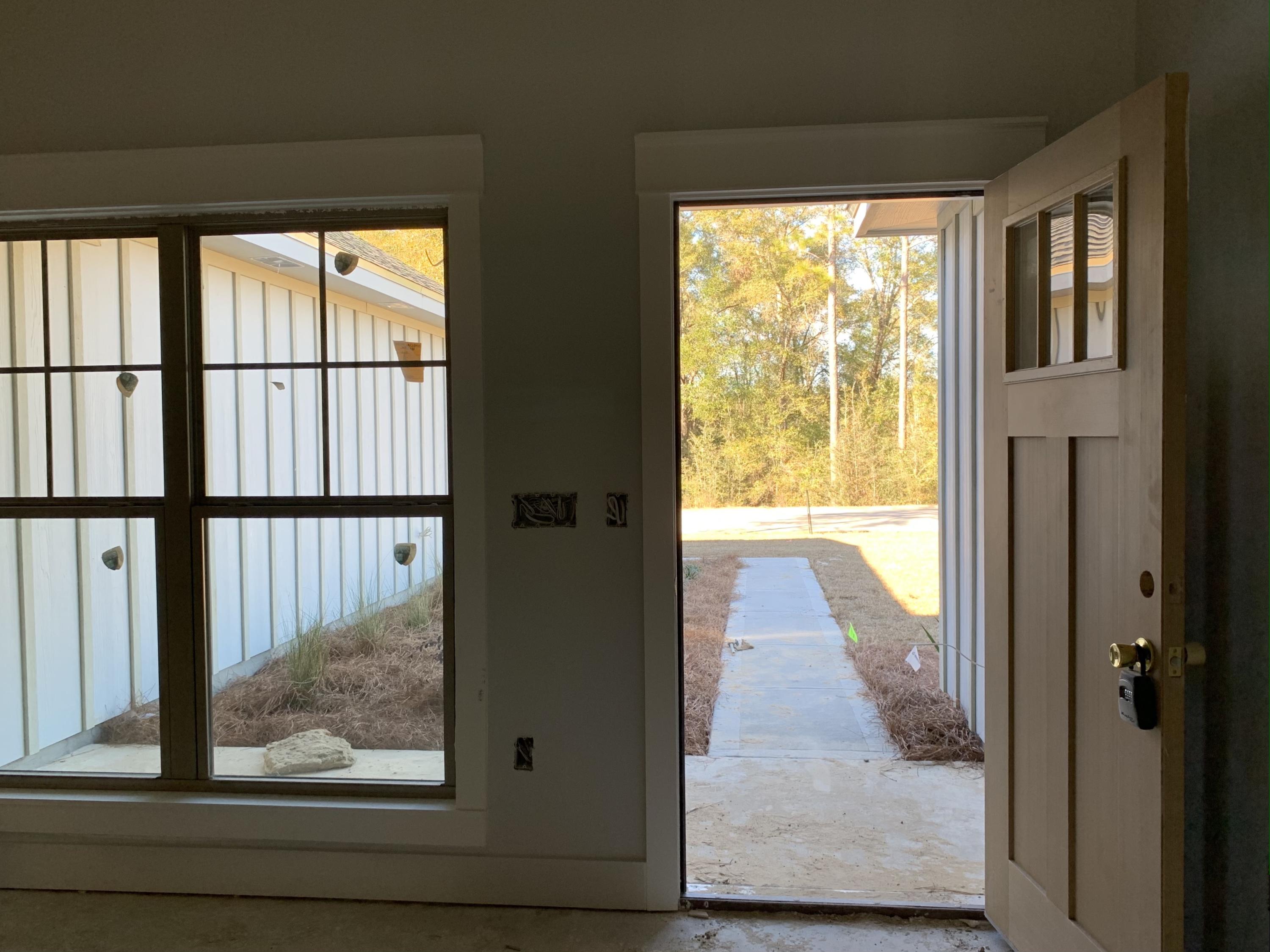 311 Arroyo Hondo Terrace Crestview, FL 32536 - Photo 11 of 12 a view of hallway with wooden floor and a floor to ceiling window