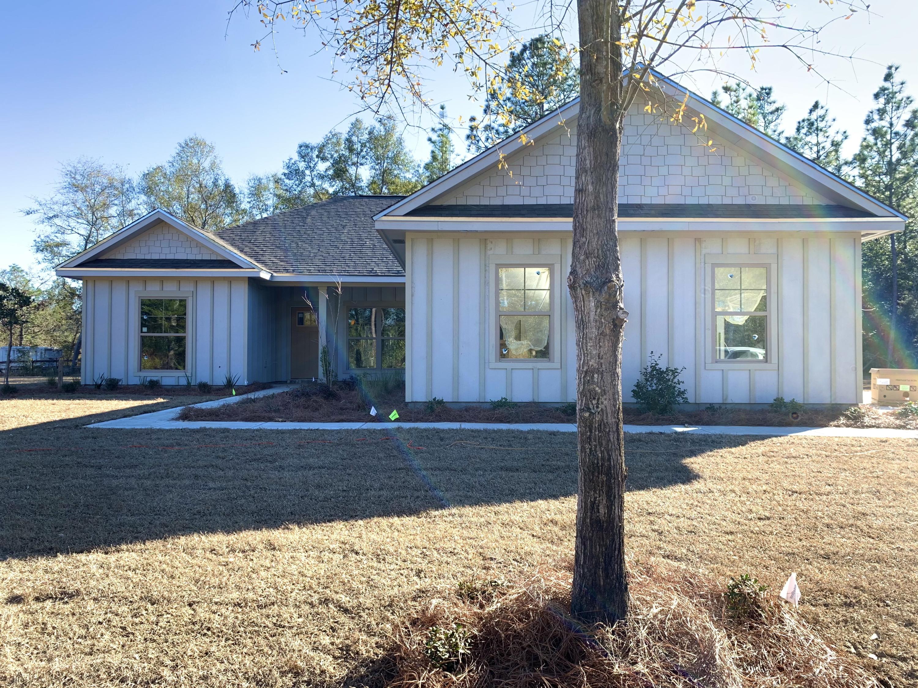 311 Arroyo Hondo Terrace Crestview, FL 32536 - Photo 12 of 12 a front view of a house with garden
