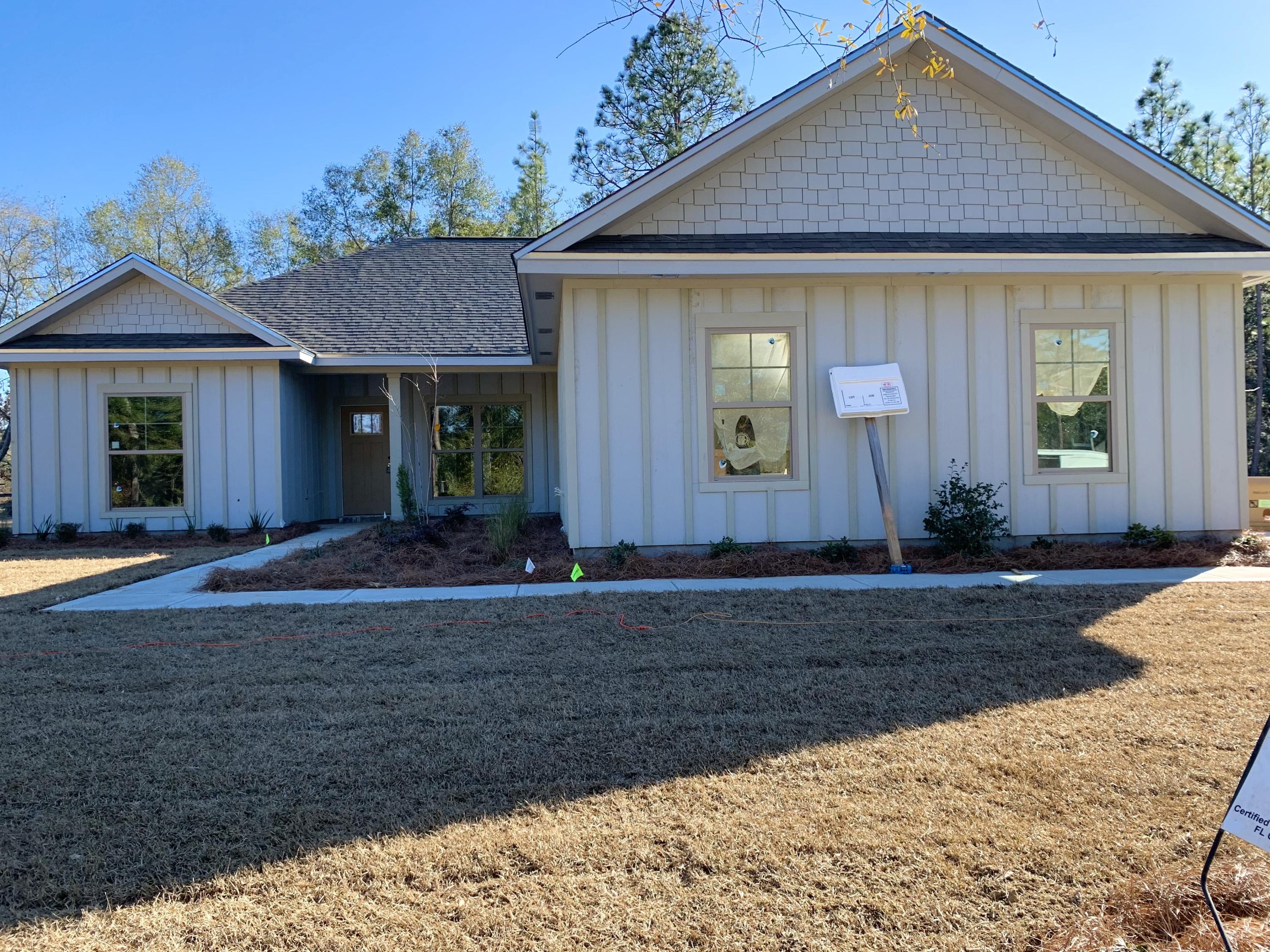 311 Arroyo Hondo Terrace Crestview, FL 32536 - Photo 2 of 12 a front view of a house with garden