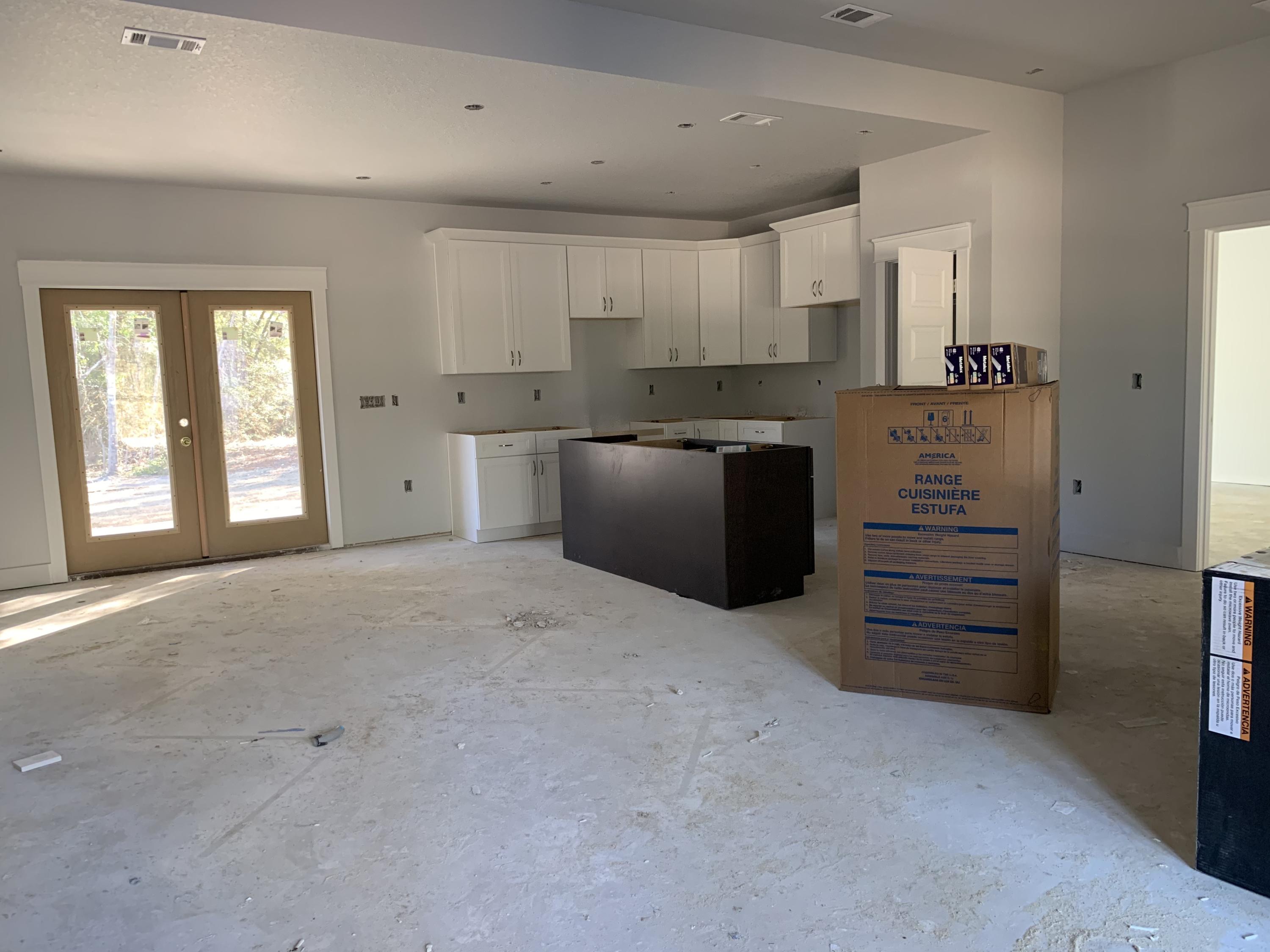 311 Arroyo Hondo Terrace Crestview, FL 32536 - Photo 4 of 12 a view of a kitchen with cabinet and refrigerator