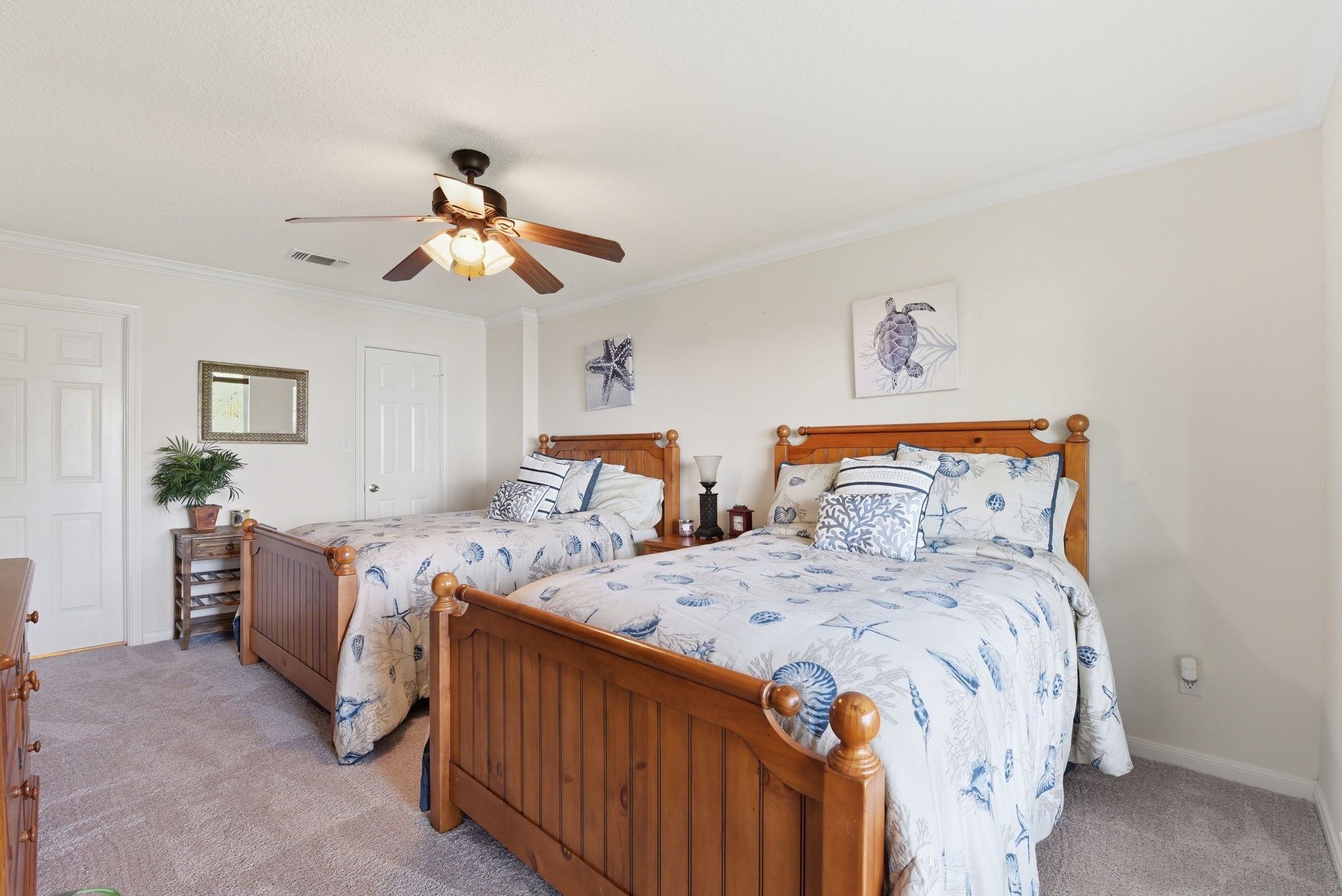 201 Lords Circle Coldspring, TX 77331 - Photo 28 of 48 a bedroom with two beds and a chandelier