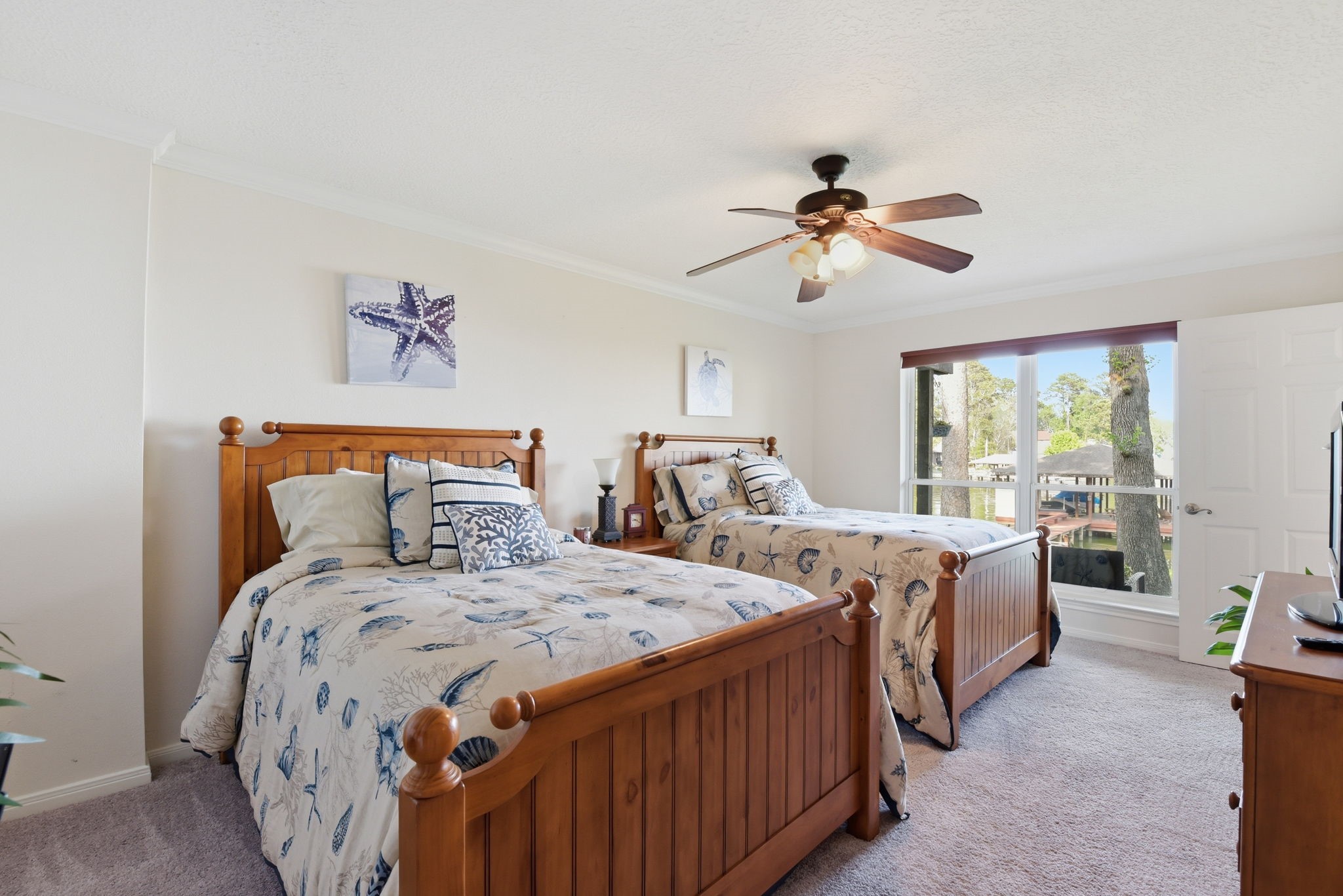 201 Lords Circle Coldspring, TX 77331 - Photo 29 of 48 a bedroom with two beds and a chandelier