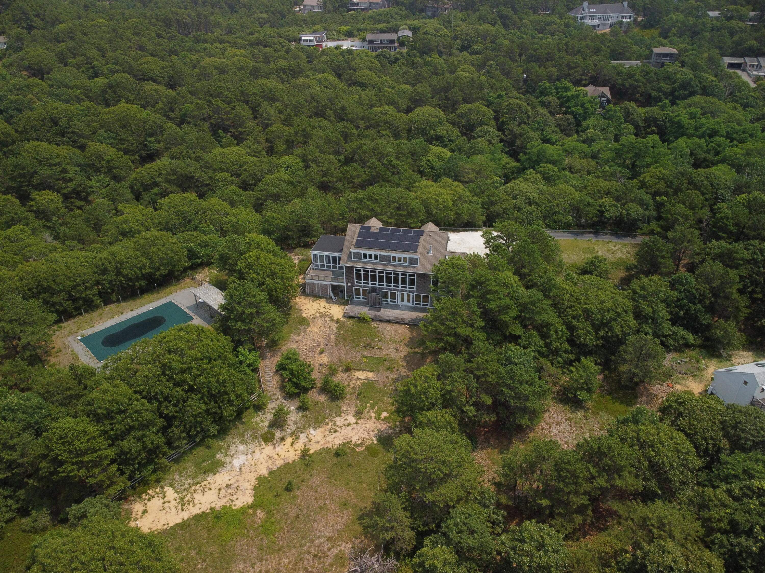 11 Cooper Road Truro, MA 02666 - Photo 1 of 8 a view of a big yard with plants and large trees