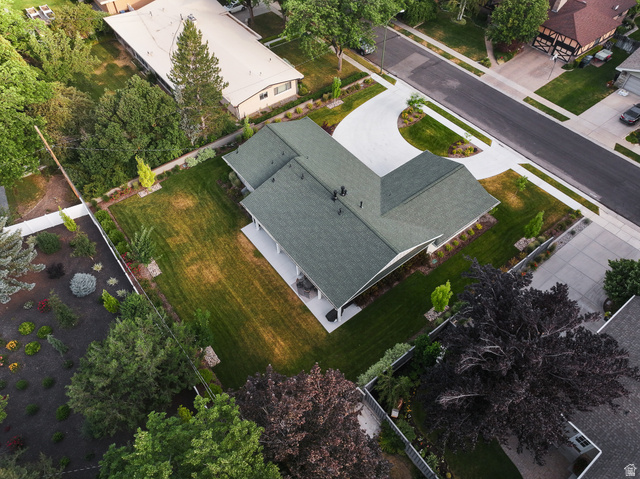 1774 Country Club Drive Logan, UT 84321 - Photo 24 of 28 Expansive property featuring a dark green shingled roof, a paved driveway, a large lawn, and mature trees