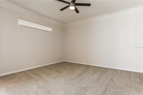 a view of a room with a ceiling fan