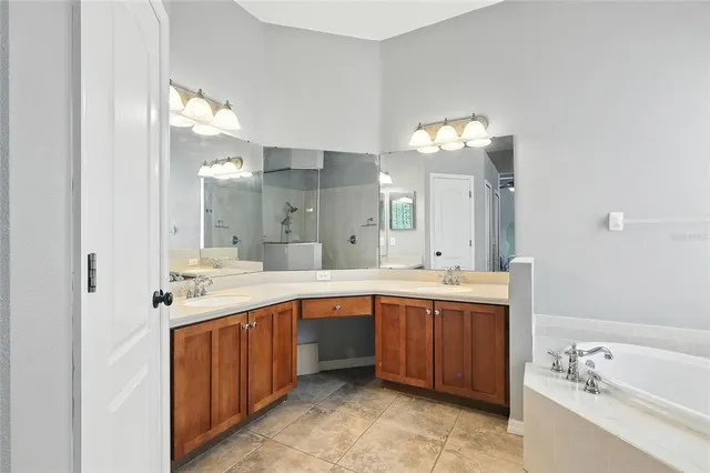 a spacious bathroom with a sink double vanity and a mirror