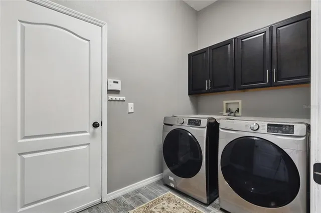 a view of walk in closet with washer and dryer